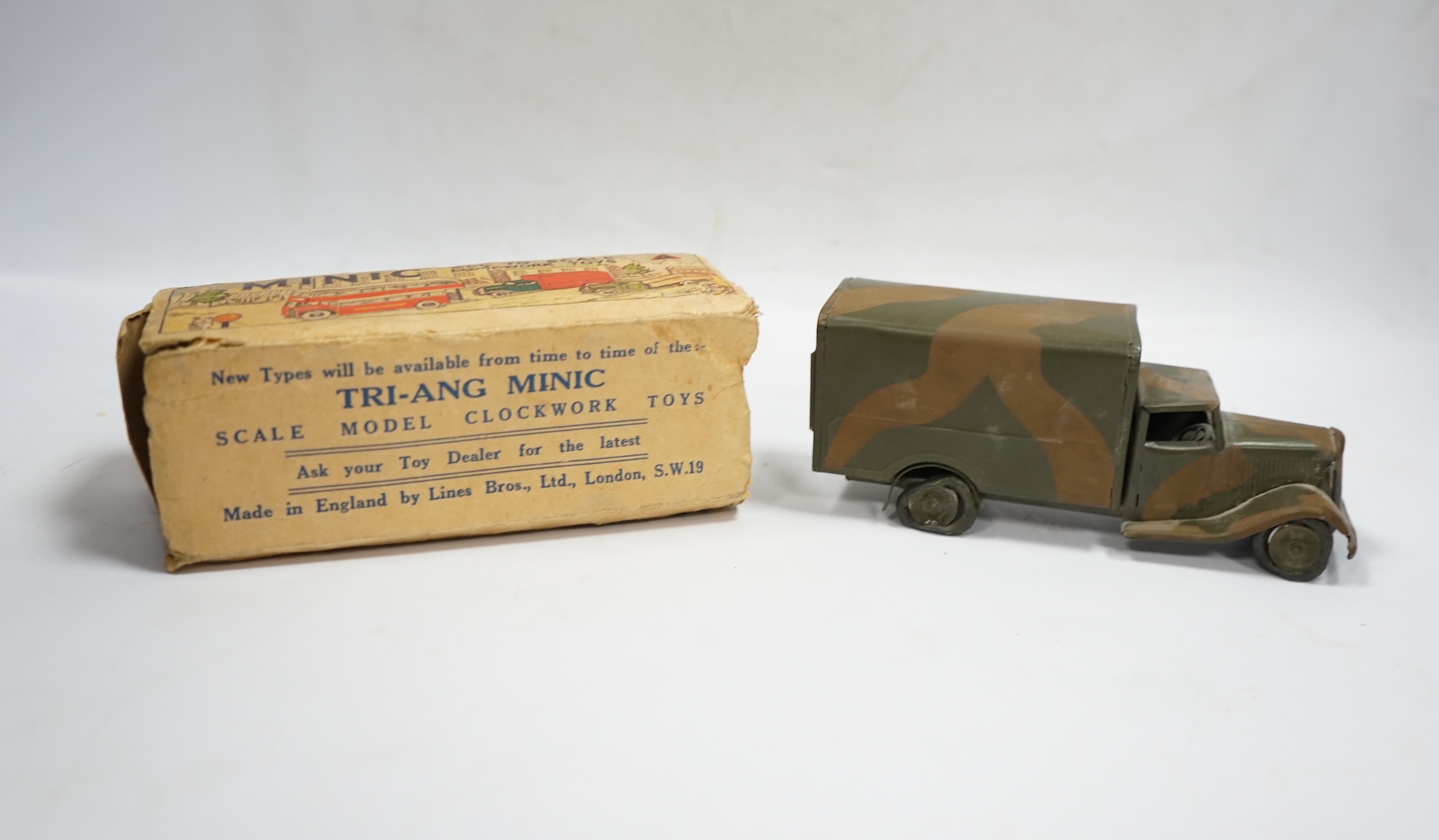 A Tri-ang Minic clockwork tinplate army lorry, in camouflage paint work, together with the remains of its box. Condition fair, original tires fatigued as expected, the box with missing flaps.